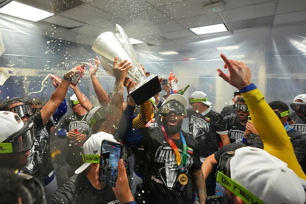 The Venezuela team celebrate with the trophy after defeating the United States in the championship game of the World Baseball Classic, Tuesday, March 17, 2026, in Miami. (AP Photo/Rebecca Blackwell)
