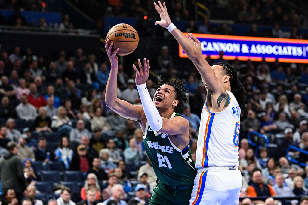 Milwaukee Bucks forward Ousmane Dieng (21) shoots against Oklahoma City Thunder forward Jaylin Williams during the first half of an NBA basketball game Thursday, Feb. 12, 2026, in Oklahoma City. (AP Photo/Gerald Leong)