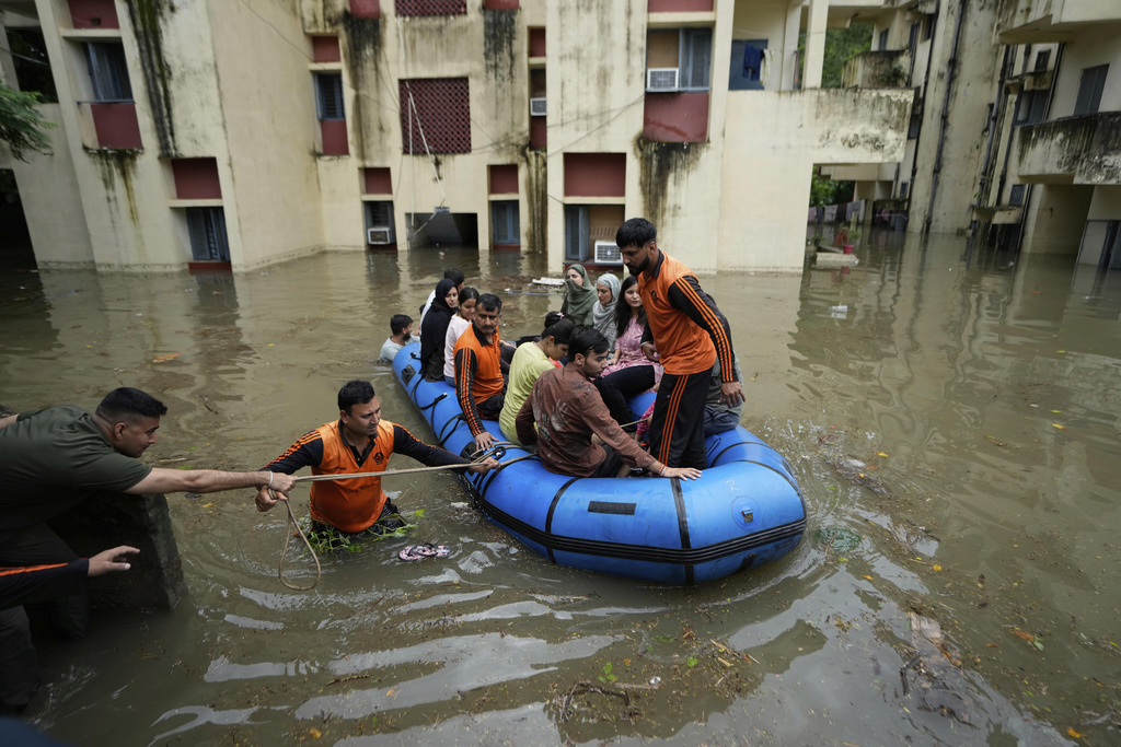 FILE - Members of the State Disaster Response Force (SDRF) rescue students stranded in a hostel due to flooding caused by heavy rains in Jammu, India, Aug. 24, 2025. (AP Photo/Channi Anand, File)