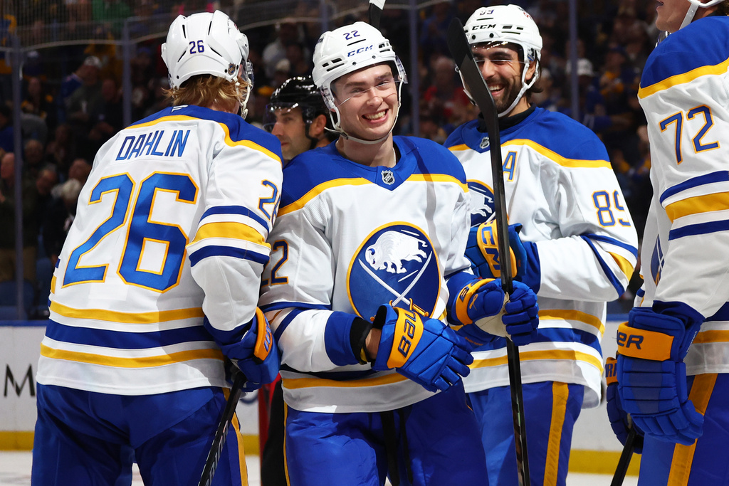Buffalo Sabres right wing Jack Quinn (22) celebrates his goal with defenseman Rasmus Dahlin (26) and forward Alex Tuch (89) during the first period of an NHL hockey game against the Ottawa Senators Wednesday, Oct. 15, 2025, in Buffalo, N.Y. (AP Photo/Jeffrey T. Barnes)