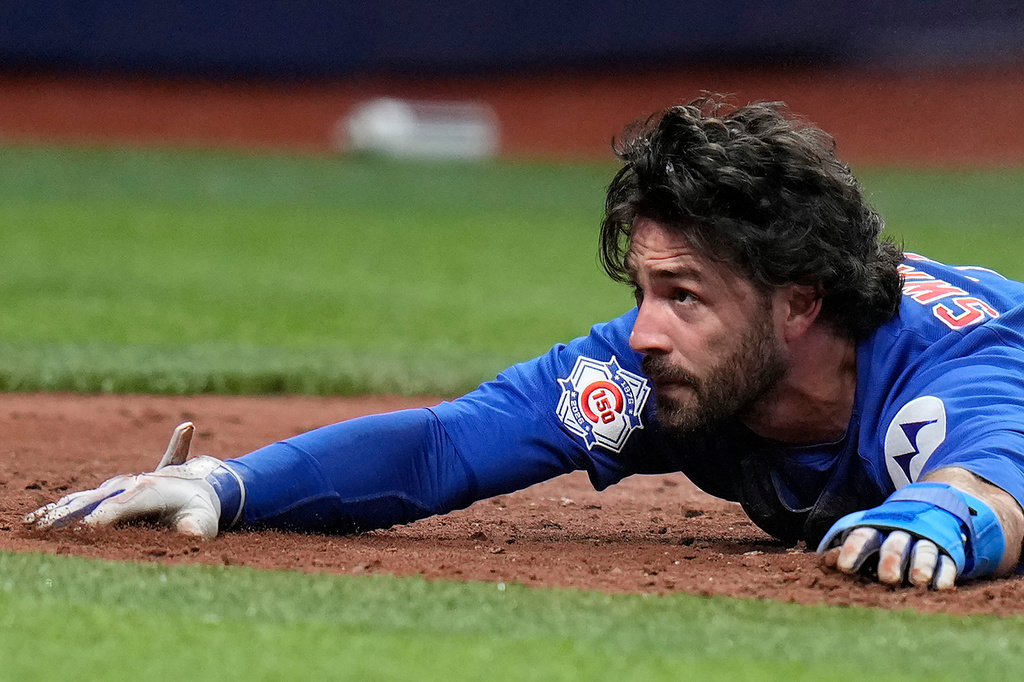 Chicago Cubs' Dansby Swanson reacts after scoring on a two-run double by Michael Conforto off Tampa Bay Rays pitcher Joe Boyle during the fifth inning of a baseball game Wednesday, April 8, 2026, in St. Petersburg, Fla. (AP Photo/Chris O'Meara)