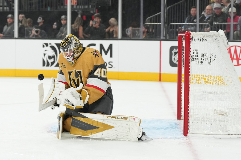 Vegas Golden Knights goaltender Akira Schmid (40) stops a shot from the Detroit Red Wings in the first period of an NHL hockey game Tuesday, Nov. 4, 2025, in Las Vegas. (AP Photo/Candice Ward)