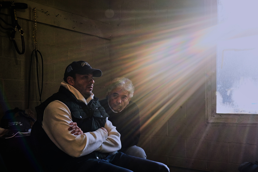 Trainers Gustavo Delgado Sr. and his son Gustavo Delgado Jr. watch a video of workouts after taking their horse, Kentucky Derby entrant The Puma, for a workout at Churchill Downs Thursday, April 30, 2026, in Louisville, Ky. (AP Photo/Charlie Riedel)