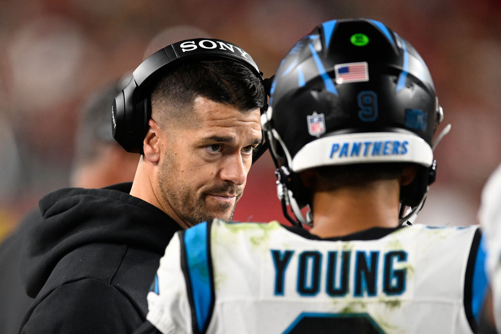 Carolina Panthers head coach Dave Canales talks with quarterback Bryce Young during the first half an NFL football game against the San Francisco 49ers, Monday, Nov. 24, 2025, in Santa Clara, Calif. (AP Photo/Eakin Howard)