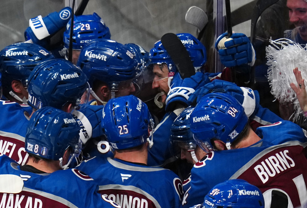 Colorado Avalanche center Nicolas Roy (10) is congratulated by teammates after scoring the game winning goal against the Los Angeles Kings in overtime of Game 2 in the first round of the NHL hockey Stanley Cup playoffs, Tuesday, April 21, 2026, in Denver. (AP Photo/Jack Dempsey)