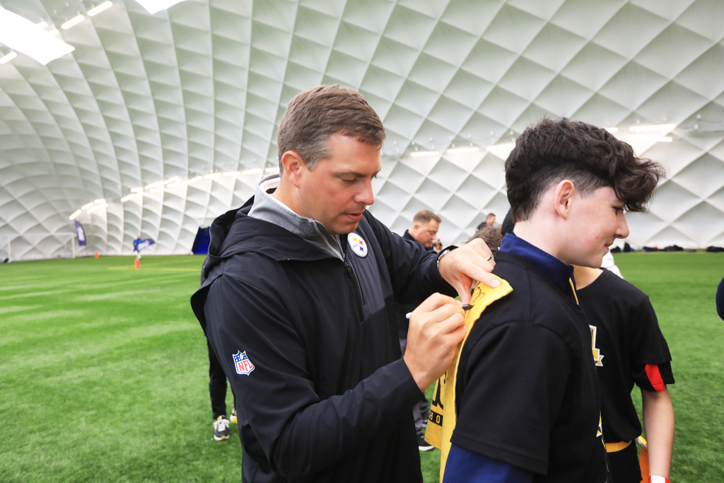 Pittsburgh Steelers' Dan Rooney signs autographs at the NFL Flag Football in Belfast, Northern Ireland, Thursday, Sept 25, 2025. (Peter Morrison/AP Content Services for the NFL)