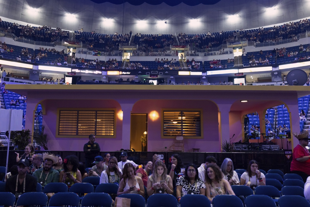 Fans sit in front of "La Casita" before Bad Bunny final concert of his summer residency in his homeland at the Coliseo de Puerto Rico Jose Miguel Agrelot, in San Juan, Puerto Rico, Saturday, Sept. 20, 2025. (AP Photo/Alejandro Granadillo)