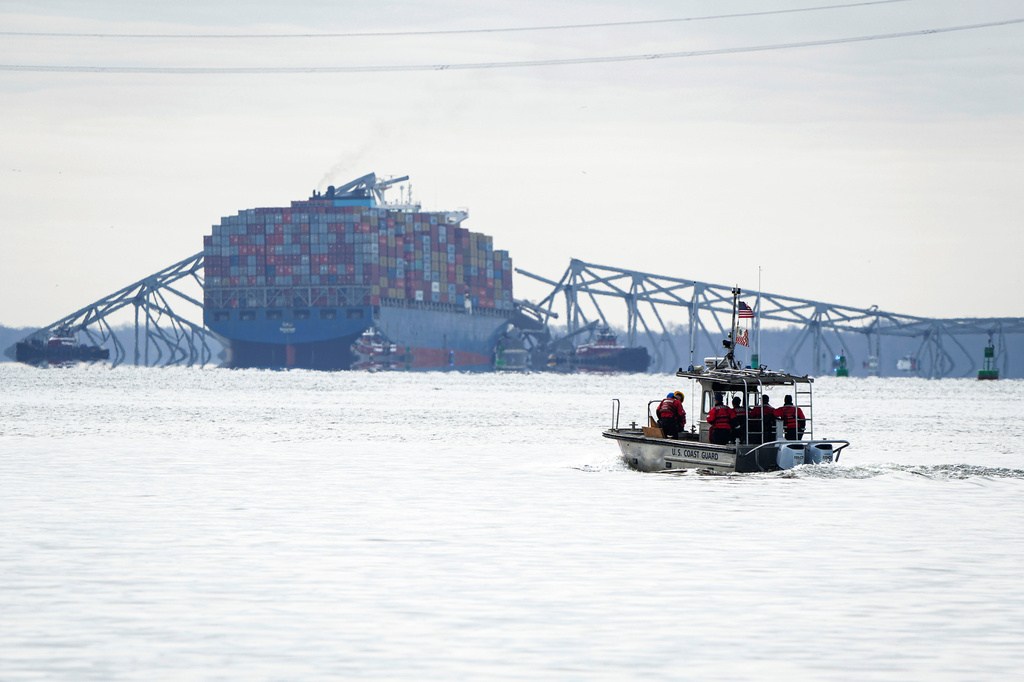 FILE - A U.S. Coast Guard boat heads toward the collapsed Francis Scott Key Bridge wreckage seen from Ft. McHenry, Md., March 26, 2024. (Ulysses Muñoz/The Baltimore Banner via AP, File)