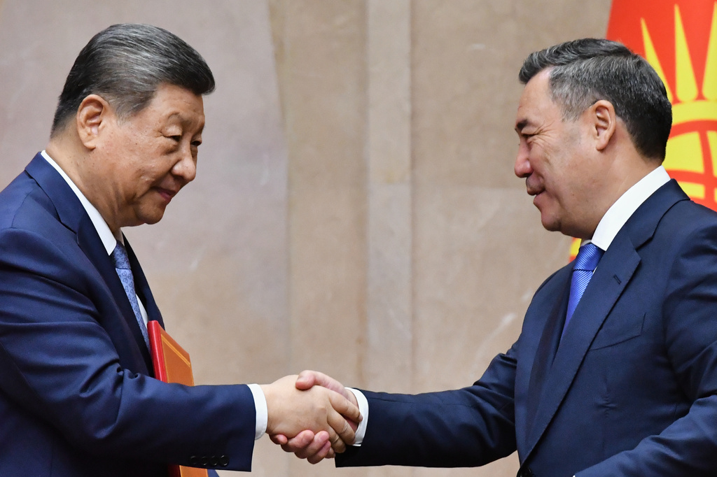 Chinese President Xi Jinping, left, and Kyrgyz President Sadyr Zhaparov shake hands during a signing ceremony at the Yntymak Ordo state residence in Bishkek, Kyrgyzstan, on Monday, Aug. 31, 2026. (AP Photo/Vladimir Voronin)