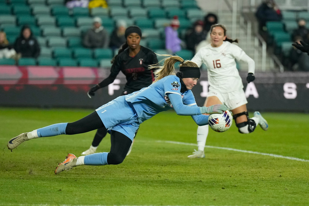 Stanford goalkeeper Caroline Birkel grabs the ball as Florida State's Sophia Nguyen (16) watches during the second half of the NCAA college soccer tournament final Monday, Dec. 8, 2025, in Kansas City, Mo. (AP Photo/Charlie Riedel)