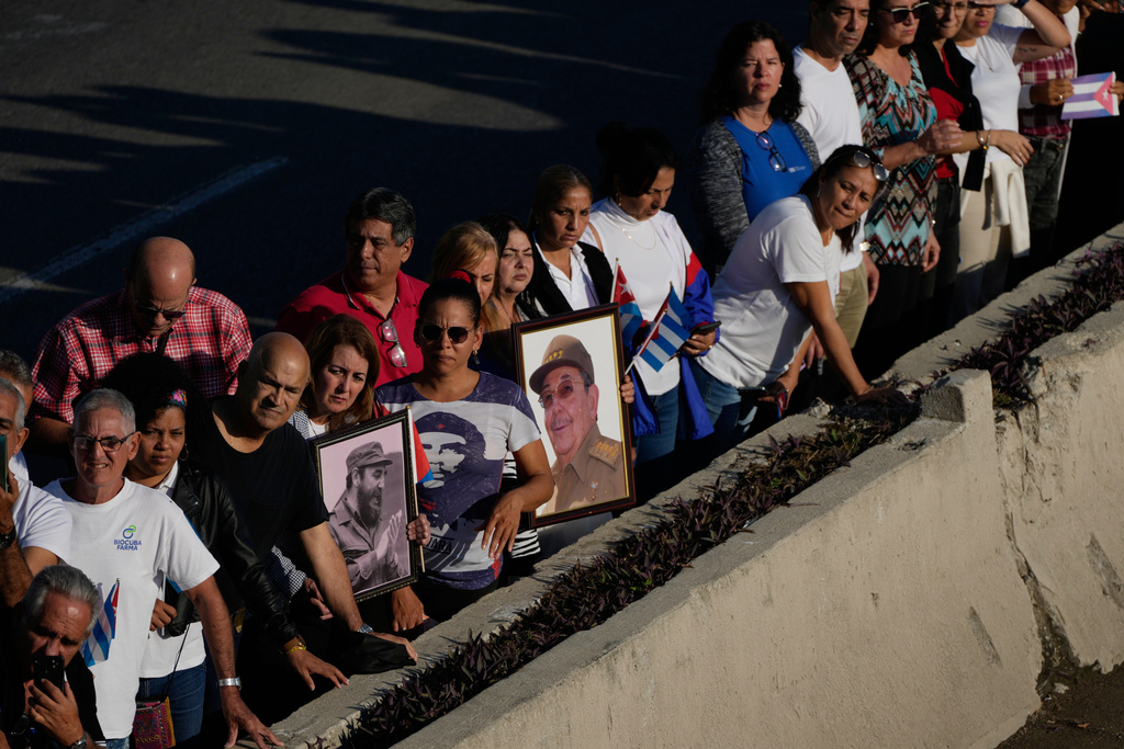 People line the streets of Havana, Cuba, Thursday, Jan. 15, 2026, to watch the motorcade carrying urns containing the remains of Cuban officers killed during the U.S. operation in Venezuela that captured Venezuelan President Nicolas Maduro. (AP Photo/Ramon Espinosa)