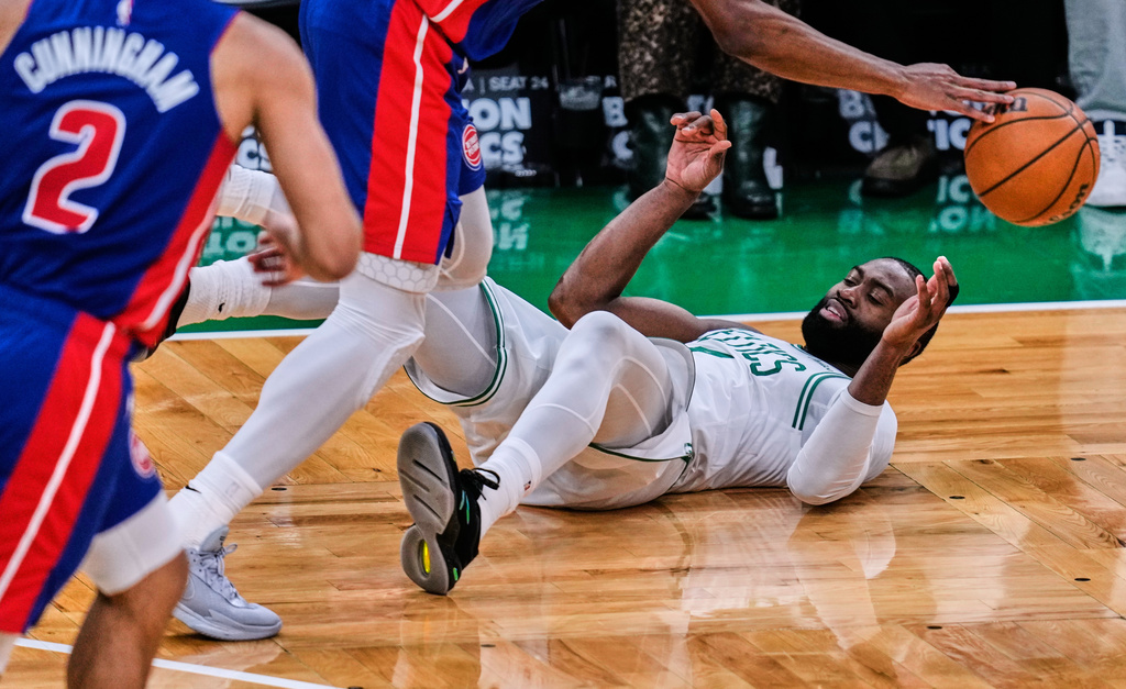 Boston Celtics guard Jaylen Brown is knocked to the floor by Detroit Pistons guard Ausar Thompson, top, during the second half of an NBA basketball game, Monday, Dec. 15, 2025, in Boston. (AP Photo/Charles Krupa)