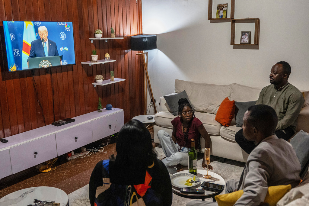 A family watches the live broadcast of the signing ceremony for the peace agreement between Rwanda and the DRC in Goma, Democratic Republic of the Congo, Dec. 4, 2025. (AP Photo/Moses Sawasawa)
