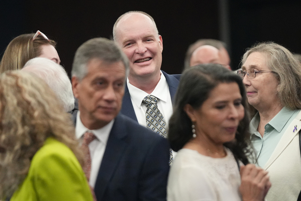 Michael Scott smiles after being exonerated at a hearing for four men wrongfully accused in the 1991 Austin yogurt shop murders at the Blackwell-Thurman Criminal Justice Center in Austin, Texas, Thursday, Feb. 19, 2026. (Jay Janner/Austin American-Statesman via AP)