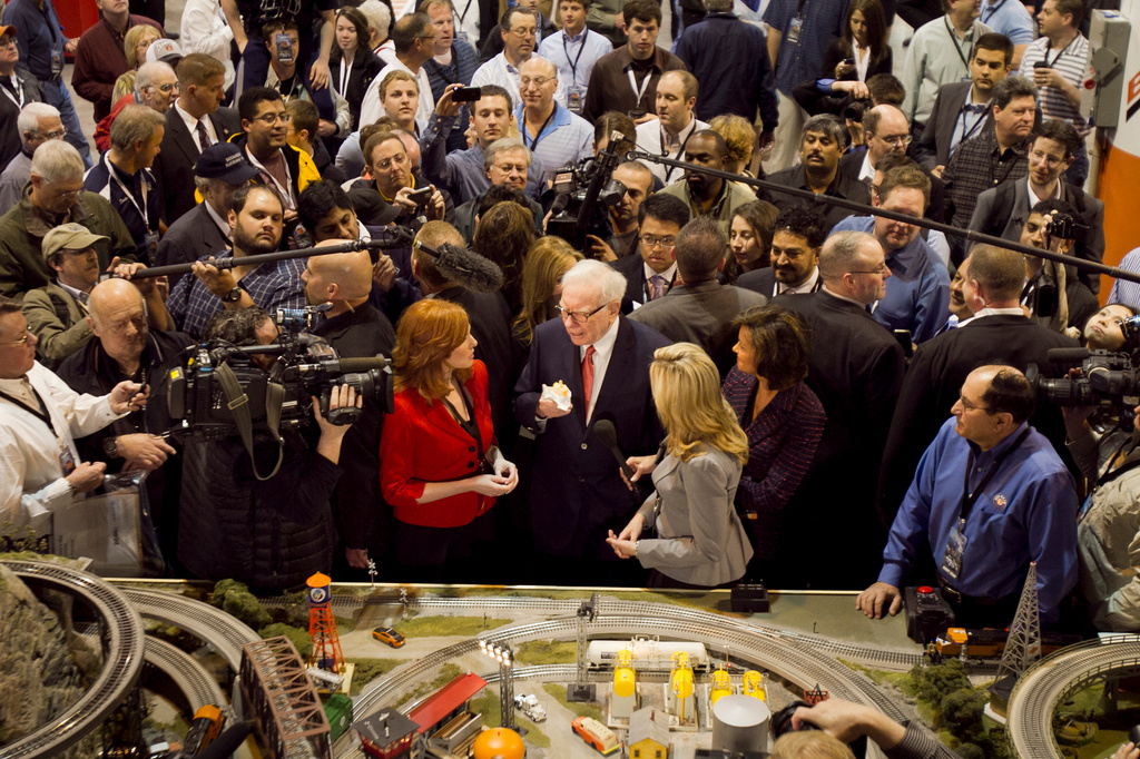 FILE - Berkshire Hathaway Chairman and CEO Warren Buffett, center, is surrounded by journalists and shareholders as he stops by a model railroad while touring the exhibit floor where Berkshire subsidiaries display their products in Omaha, Neb., April 30, 2011, prior to presiding over the annual Berkshire Hathaway shareholders meeting. (AP Photo/Nati Harnik, File)