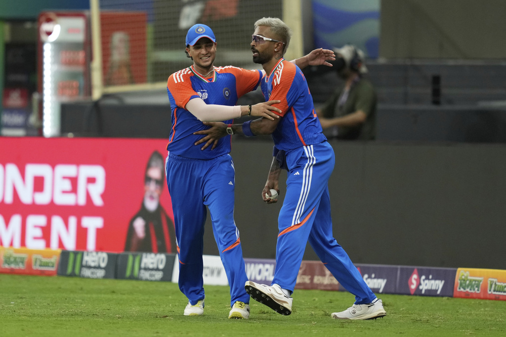 India's Hardik Pandya, right, celebrates with teammate Abhishek Sharma after taking the catch to dismiss Pakistan's Sahibzada Farhan during the Asia Cup cricket match between India and Pakistan at Dubai International Cricket Stadium in Dubai, United Arab Emirates, Sunday, Sept. 14, 2025. (AP Photo/Altaf Qadri)