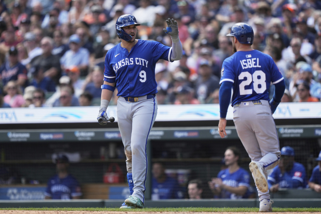 Kansas City Royals' Vinnie Pasquantino, left, celebrates with Kyle Isbel, who scored off a wild pitch by Detroit Tigers relief pitcher Tyler Holton, during the sixth inning of a baseball game Sunday, Aug. 24, 2025, in Detroit. (AP Photo/Ryan Sun)