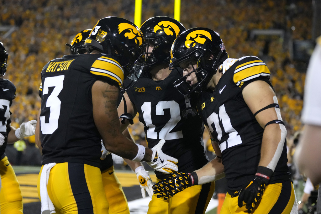 Iowa's Kaden Wetjen (21) celebrates with teammates after returning a punt for a touchdown during the second half of an NCAA college football game against Massachusetts, Saturday, Sept. 13, 2025, in Iowa City, Iowa. (AP Photo/Charlie Neibergall)