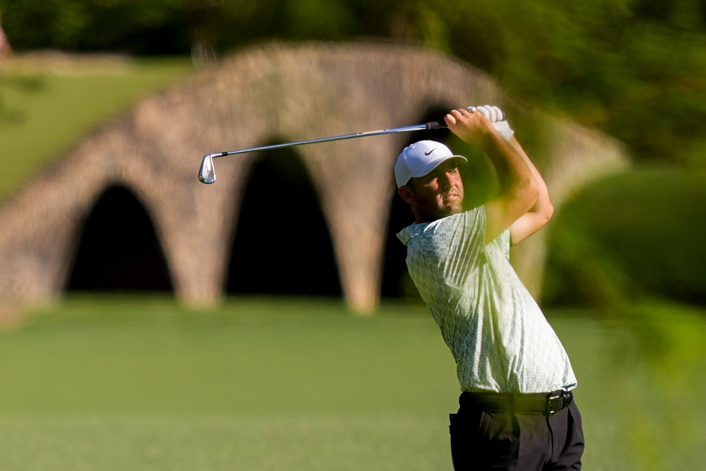 Scottie Scheffler hits from the fairway on the 13th hole during the first round of the Masters golf tournament at the Augusta National Golf Club, Thursday, April 9, 2026, in Augusta, Ga. (AP Photo/David J. Phillip)