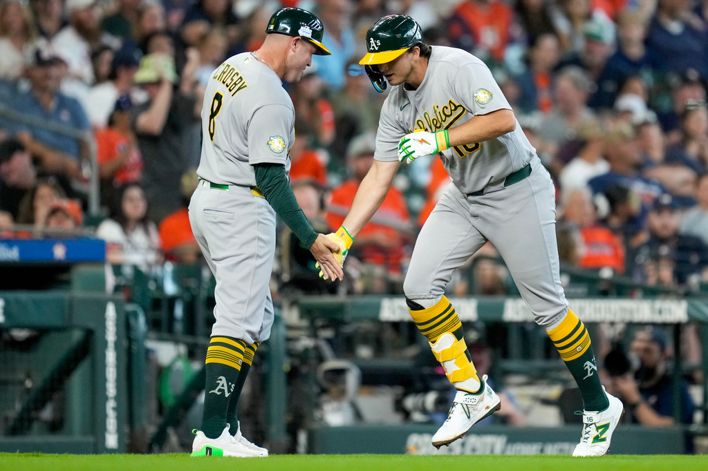 Athletics' Nick Kurtz, right, celebrates after his two-run home run against the Houston Astros with thrid base coach Bobby Crosby during the third inning of a baseball game, Sunday, June 7, 2026, in Houston. (AP Photo/Eric Christian Smith)