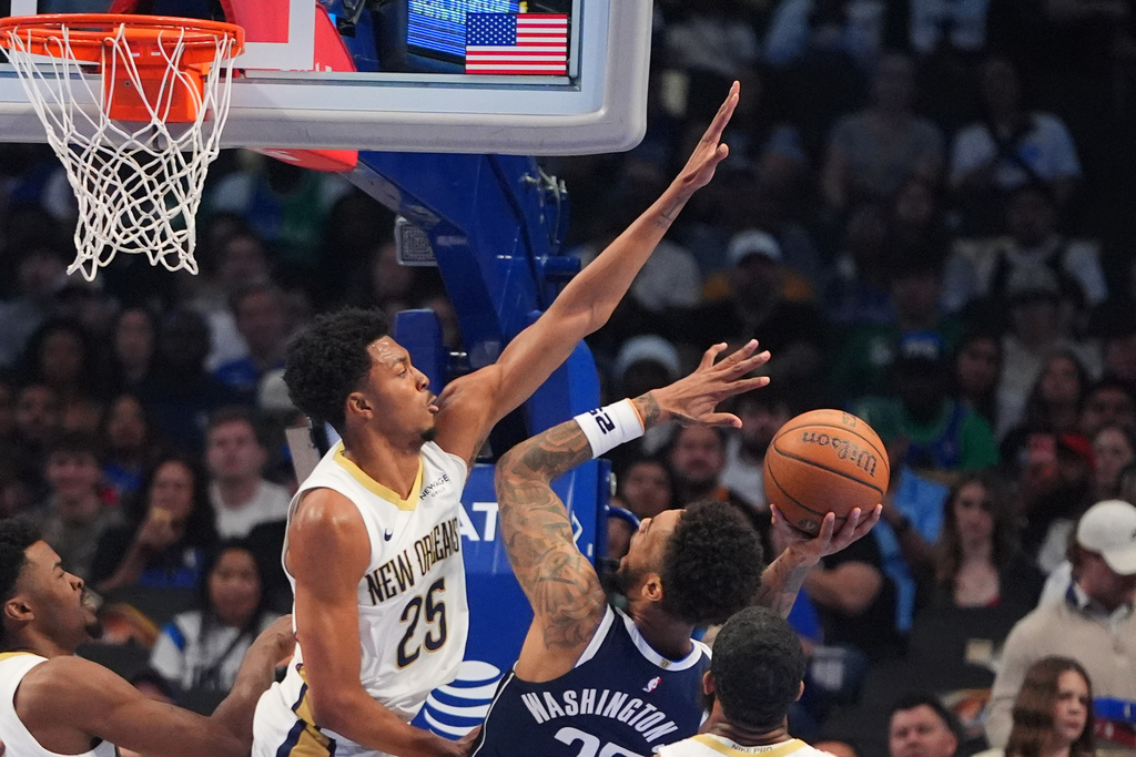 Dallas Mavericks forward P.J. Washington (25) shoots against New Orleans Pelicans forward Trey Murphy III (25) during the first half of an NBA Cup basketball game in Dallas, Friday, Nov. 21, 2025. (AP Photo/LM Otero)