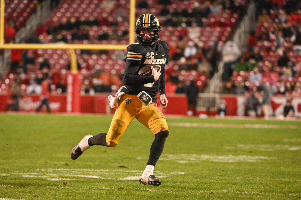 Missouri quarterback Beau Pribula runs the ball against Arkansas during the second half of an NCAA college football game Saturday, Nov. 29, 2025, in Fayetteville, Ark. (AP Photo/Michael Woods)