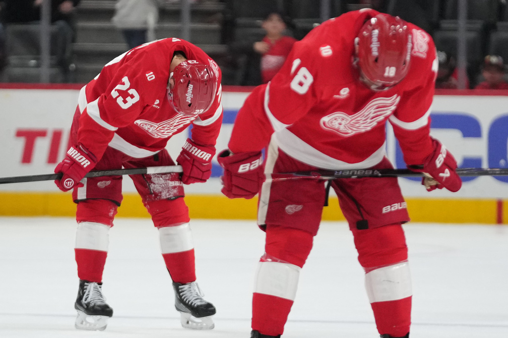Detroit Red Wings left wing Lucas Raymond (23) and Andrew Copp (18) skate to the locker room after an NHL hockey game against the Minnesota Wild Sunday, April 5, 2026, in Detroit. (AP Photo/Paul Sancya)