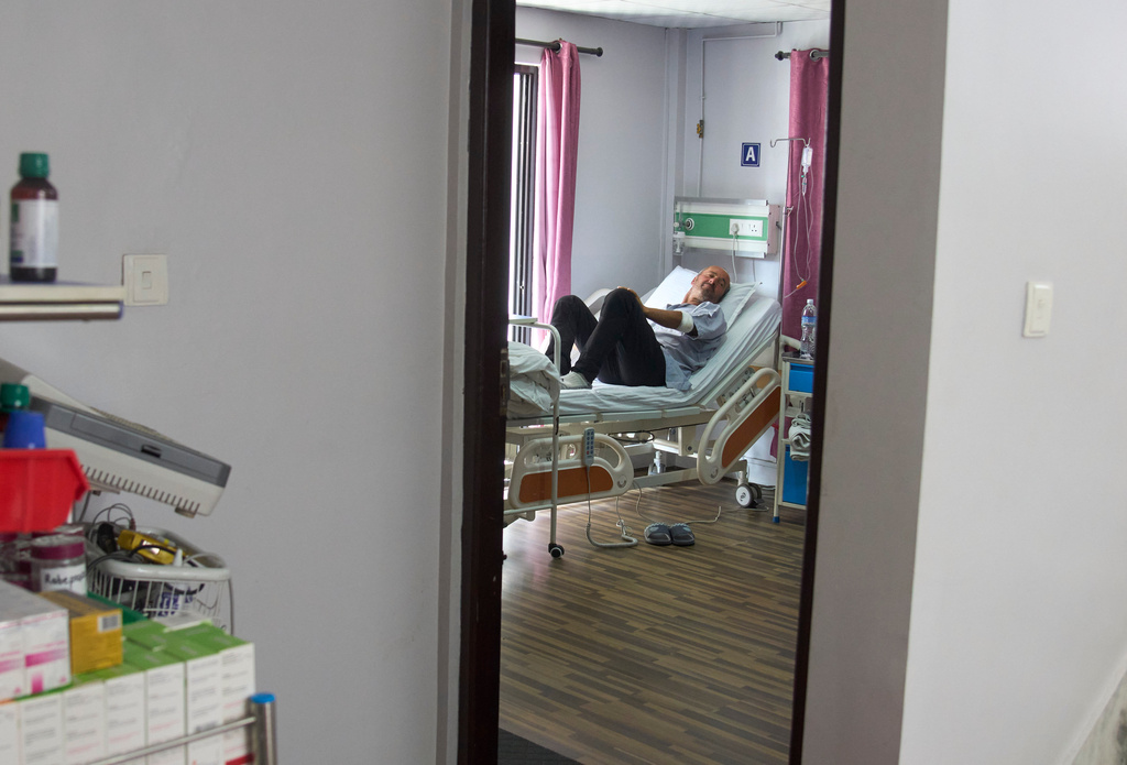 Didier Armand, a survivor of an avalanche on Mount Yalung Ri, takes rest after being rescued and airlifted to a hospital in Kathmandu, Nepal, Tuesday, Nov. 4, 2025. (AP Photo/Niranjan Shrestha)