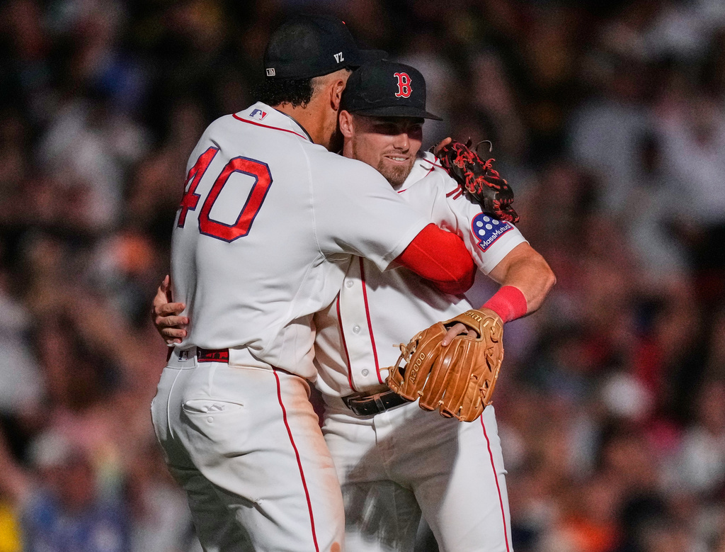 Boston Red Sox's Caleb Durbin, right, celebrates with Willson Contreras after defeating the Baltimore Orioles following a baseball game, Monday, July 20, 2026, in Boston. (AP Photo/Charles Krupa)