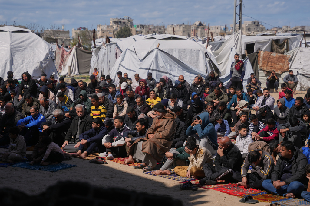 Muslim worshippers take part in the Friday prayers during the holy month of Ramadan outside the destroyed Al-Albani Mosque, in Khan Younis, southern Gaza Strip, Friday, Feb. 27, 2026. (AP Photo/Abdel Kareem Hana)