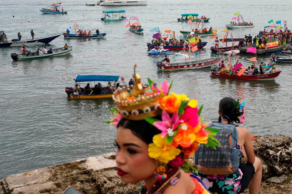 FILE - People wearing traditional pollera conga dress take part in a maritime parade as part of the the 7th Pollera Congo Festival, in Portobelo, Panama, May 2, 2026. (AP Photo/Matias Delacroix, File)