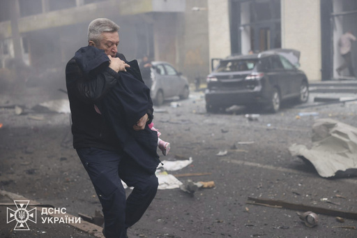 In this photo provided by the Ukrainian Emergency Service, a man evacuates a child after Russian drones hit a city kindergarten in Kharkiv, Ukraine, Wednesday, Oct. 22, 2025. (Ukrainian Emergency Service via AP) In this photo provided by the Ukrainian Emergency Service, a man evacuates a child after Russian drones hit a city kindergarten in Kharkiv, Ukraine, Wednesday, Oct. 22, 2025. (Ukrainian Emergency Service via AP)