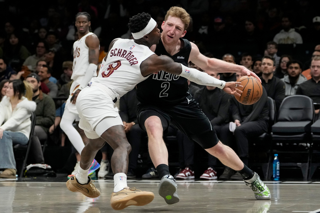 Brooklyn Nets forward Danny Wolf (2) attempts to drives past Cleveland Cavaliers guard Dennis Schroder (8) during the first half of an NBA basketball game, Sunday, March 1, 2026, in New York. (AP Photo/Yuki Iwamura)
