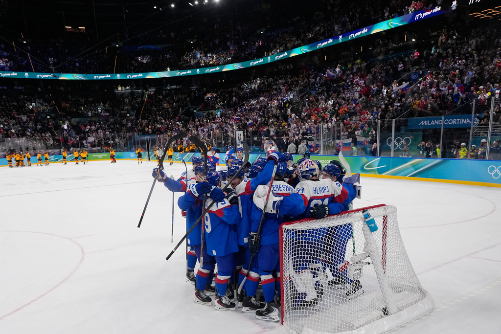 Slovakia players celebrate there victory after a men's ice hockey quarterfinal game between Slovakia and Germany at the 2026 Winter Olympics, in Milan, Italy, Wednesday, Feb. 18, 2026. (AP Photo/Petr David Josek)