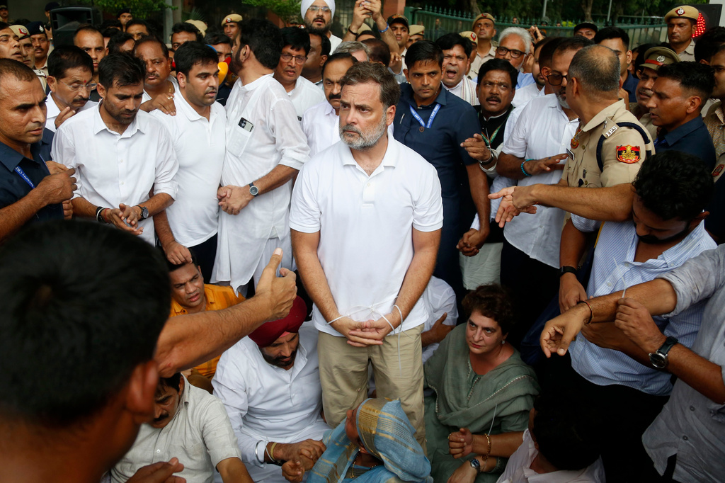 India's opposition Congress party leader Rahul Gandhi, center, with his hands tied, participates in a sit-in protest with his sister and lawmaker Priyanka Gandhi Vadra, center right, outside the residence of Prime Minister Narendra Modi in New Delhi, India, Tuesday, July 21, 2026. (AP Photo/Shekhar Yadav)