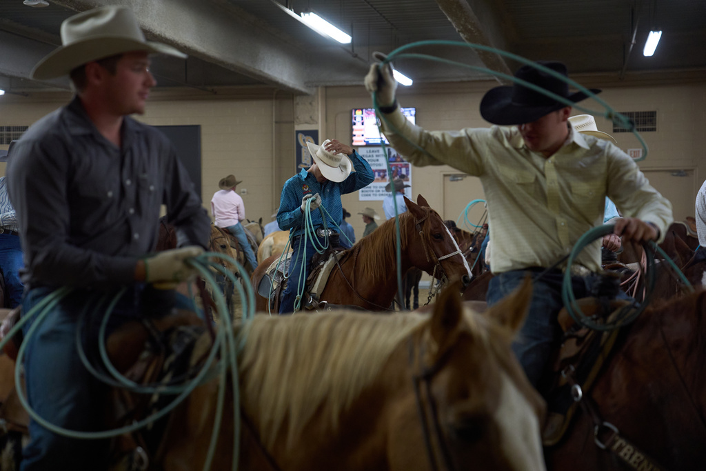 Contestants wait to compete during the World Series of Team Roping at the South Point hotel-casino in Las Vegas Tuesday, Dec. 9, 2025, in Las Vegas. (AP Photo/John Locher)