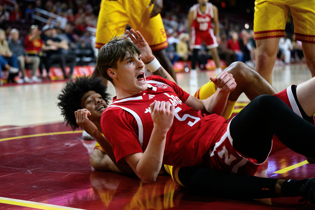 Nebraska forward Braden Frager (5) and Southern California forward Chad Baker-Mazara, left, react after a hard contact during the first half of an NCAA college basketball game Saturday, Feb. 28, 2026, in Los Angeles. (AP Photo/William Liang)
