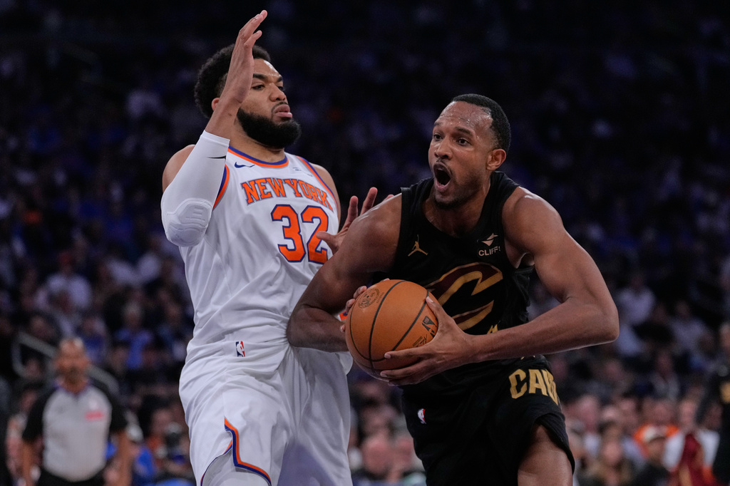 Cleveland Cavaliers' Evan Mobley, right, drives past New York Knicks' Karl-Anthony Towns during the first half of Game 1 in the Eastern Conference finals NBA basketball playoffs series, Tuesday, May 19, 2026, in New York. (AP Photo/Seth Wenig)