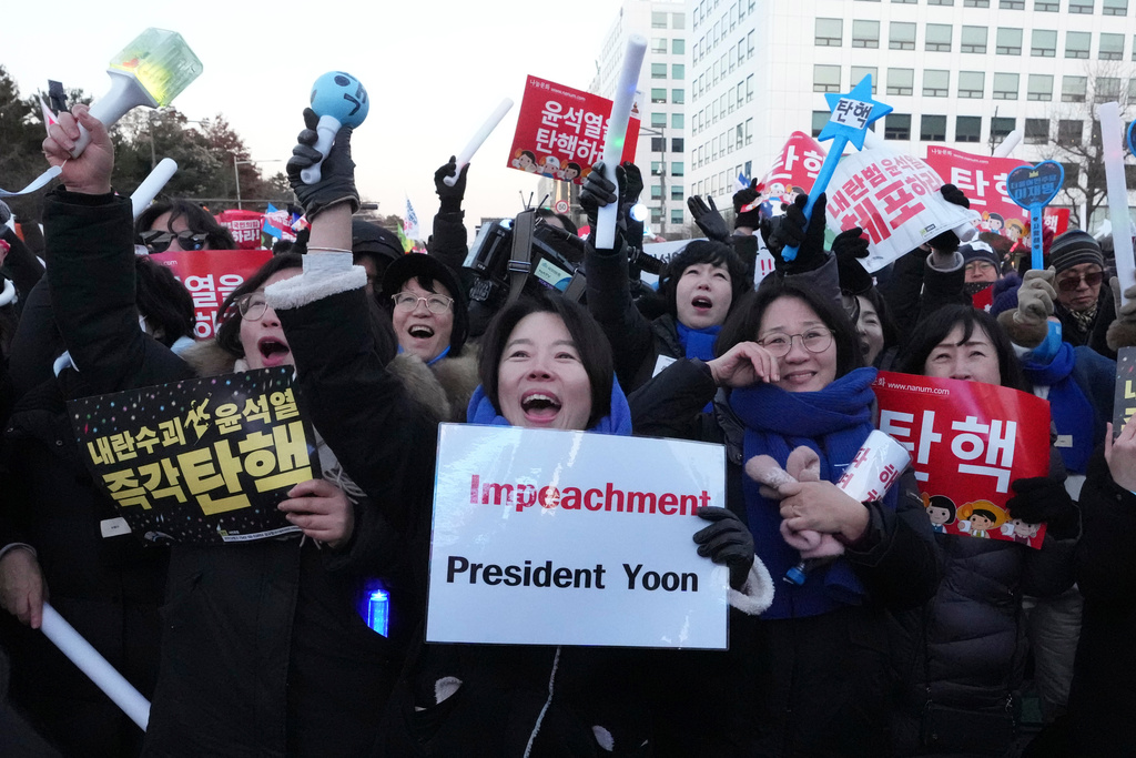FILE - Participants react after hearing the news that South Korea's parliament voted to impeach President Yoon Suk Yeol outside the National Assembly in Seoul, South Korea, on Dec. 14, 2024. (AP Photo/Lee Jin-man, File)