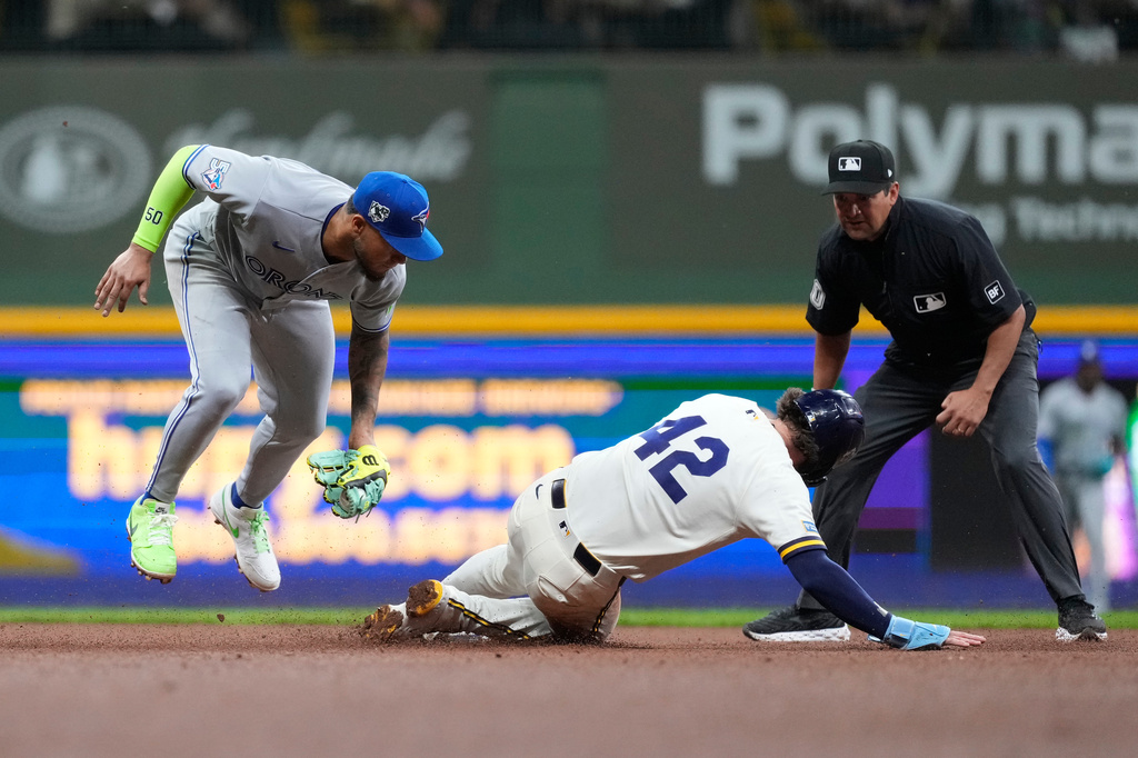 Toronto Blue Jays' Lenyn Sosa, left, tags out Milwaukee Brewers' Brice Turang at second base during the sixth inning of a baseball game Wednesday, April 15, 2026, in Milwaukee. (AP Photo/Aaron Gash)