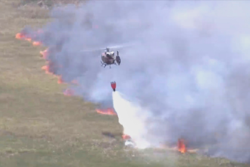 This image taken from a WSVN video shows firefighters battling a wildfire Wednesday, April 22, 2026, in Broward County, Fla. (WSVN/ABC Miami via AP)
