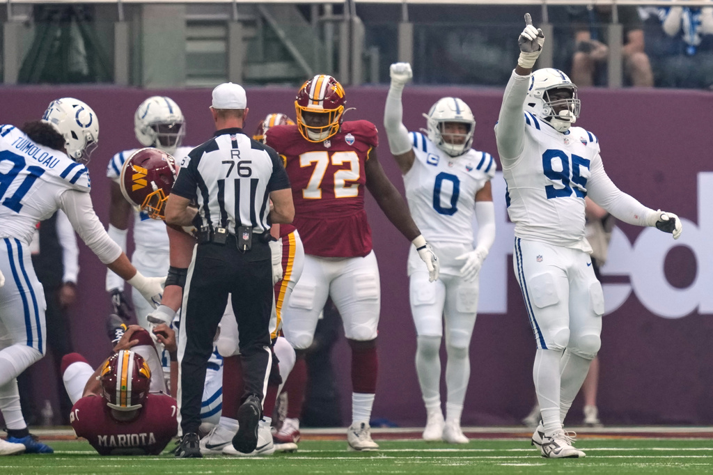Indianapolis Colts defensive tackle Adetomiwa Adebawore (95) reacts after Washington Commanders quarterback Marcus Mariota (8), left, was sacked during an NFL football game in London, Sunday, Oct. 4, 2026. (AP Photo/David J. Phillip)