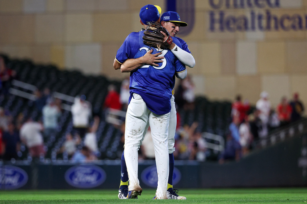 Minnesota Twins third baseman Brooks Lee and first baseman Royce Lewis celebrate their teams win against the St. Louis Cardinals during the ninth inning of a baseball game, Friday, June 12, 2026, in Minneapolis. (AP Photo/Matt Krohn)