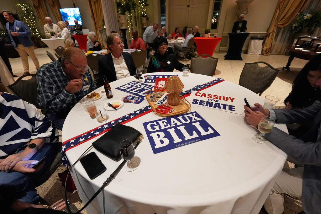 Attendees sit at a table during an election night watch party for Sen. Bill Cassidy, R-La., Saturday, May 16, 2026, in Baton Rouge, La. (AP Photo/Gerald Herbert)