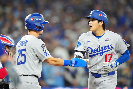 Los Angeles Dodgers' Shohei Ohtani (17) celebrates with Tommy Edman (25) after hitting a two-run home run against the Toronto Blue Jays during the seventh inning of Game 1 of baseball's World Series in Toronto, Friday, Oct. 24, 2025. (Frank Gunn/The Canadian Press via AP) Los Angeles Dodgers' Shohei Ohtani (17) celebrates with Tommy Edman (25) after hitting a two-run home run against the Toronto Blue Jays during the seventh inning of Game 1 of baseball's World Series in Toronto, Friday, Oct. 24, 2025. (Frank Gunn/The Canadian Press via AP)
