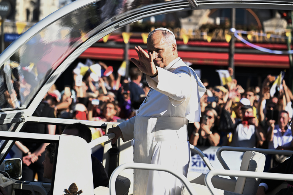 Pope Leo XIV waves the crowd in the streets of Paris, Friday, Sept. 25, 2026. (AP Photo/Emma Da Silva)