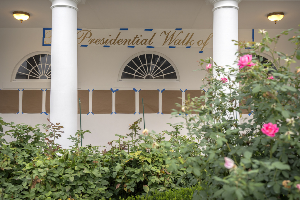 A sign reading "The Presidential Walk of Fame" and pieces of brown paper are taped along the wall of the White House colonnade next to the Rose Garden, Sunday, Sept. 21, 2025, in Washington. (AP Photo/Mark Schiefelbein)