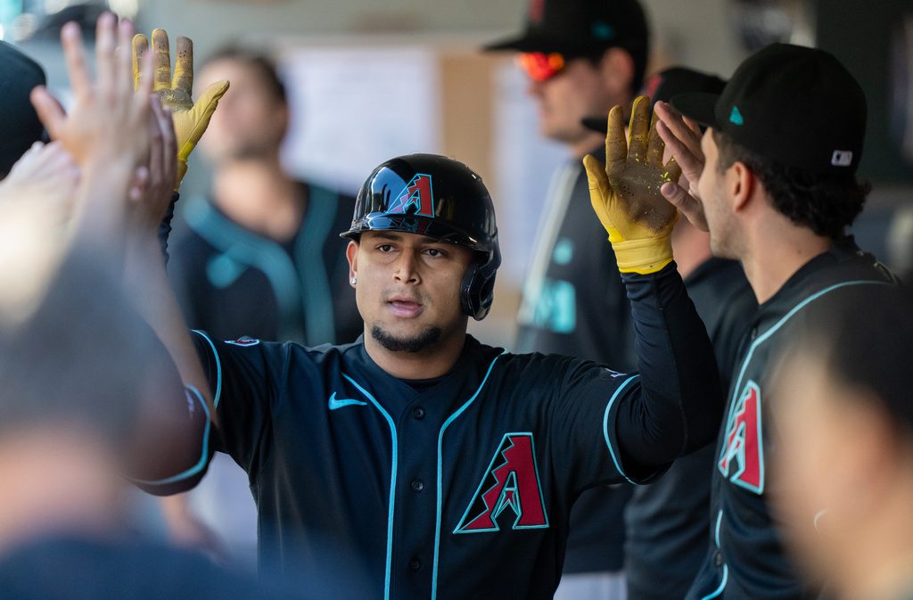 Arizona Diamondbacks' Gabriel Moreno is congratulated by teammates in the dugout after scoring a run during the eighth inning of a baseball game against the Seattle Mariners, Sunday, May 31, 2026, in Seattle. (AP Photo/Stephen Brashear)