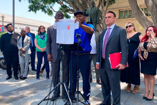 FILE - Jonathan Wright, 39, holds up the T-shirt he was given when he first went to MacLaren Children's Center in El Monte as an 8-year-old during a news conference in Los Angeles, June 9, 2022. (AP Photo/Christopher Weber, File) FILE - Jonathan Wright, 39, holds up the T-shirt he was given when he first went to MacLaren Children's Center in El Monte as an 8-year-old during a news conference in Los Angeles, June 9, 2022. (AP Photo/Christopher Weber, File)
