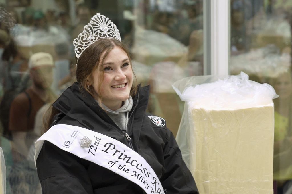 Princess Kay of the Milky Way Malorie Thorson sits in a 40-degree rotating cooler for her likeness to be carved from a 90-pound block of butter by sculptor Gerry Kulzer at the Minnesota State Fair on Thursday, Aug. 21, 2025 in Falcon Heights, Minn. (AP Photo/Mark Vancleave)